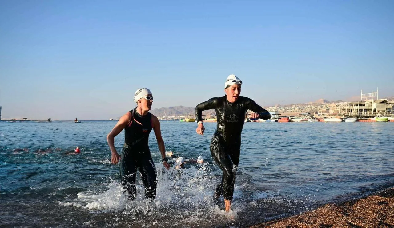 Israman athletes running out of the Red Sea at the swim exit in Eilat